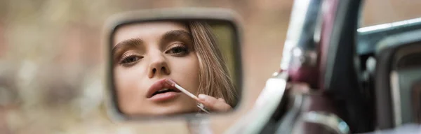 Reflection Side View Mirror Young Woman Applying Lip Gloss Blurred — Stock Photo, Image