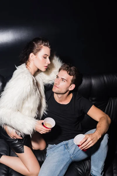 Confident Man Hugging Seductive Woman While Sitting Sofa Holding Plastic — Stock Photo, Image