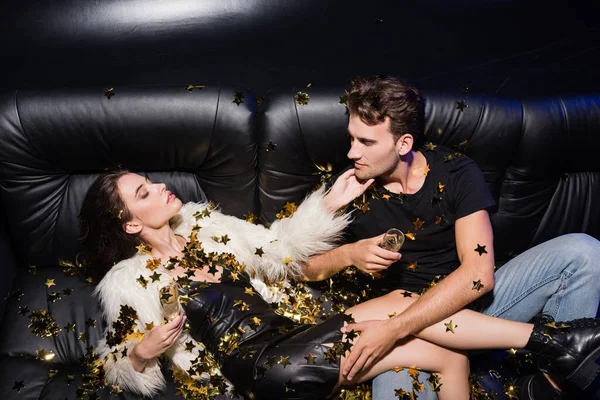 Seductive Woman Touching Boyfriend Chin Looking Each Other While Confetti — Stock Photo, Image