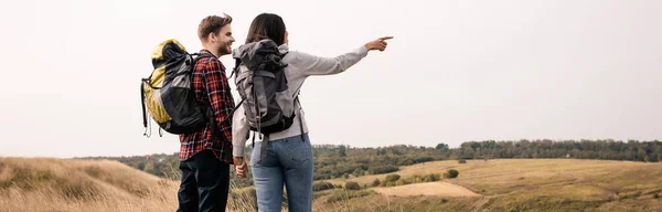 African American Hiker Pointing Finger While Holding Hand Boyfriend Outdoors — Stock Photo, Image