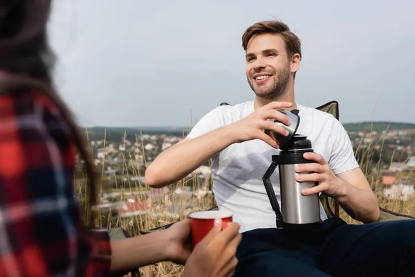 Smiling Man Holding Thermos African American Woman Cup Blurred Foreground — Stock Photo, Image