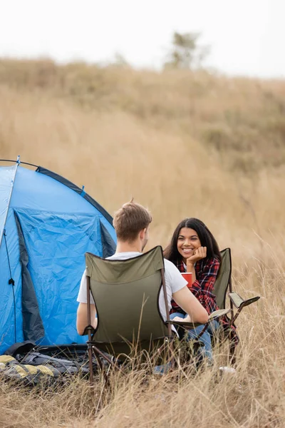 Smiling African American Woman Holding Cup Looking Boyfriend Tent Grassy — Stock Photo, Image