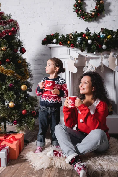 Mother Daughter Cups Looking Away Pine Fireplace Home — Stock Photo, Image