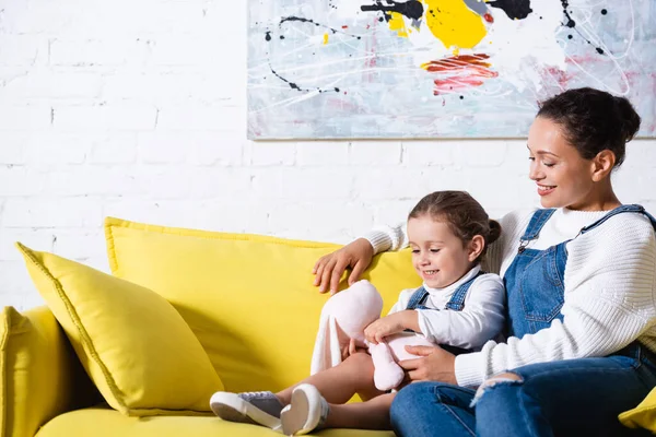 Mutter Und Tochter Mit Stofftier Auf Gelbem Sofa Hause — Stockfoto