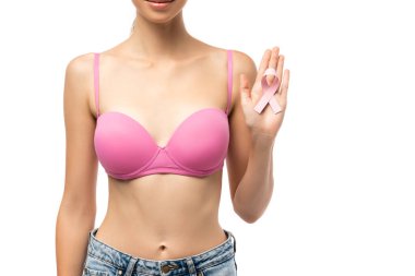 Cropped view of young woman in pink bra holding pink ribbon of breast cancer awareness isolated on white clipart