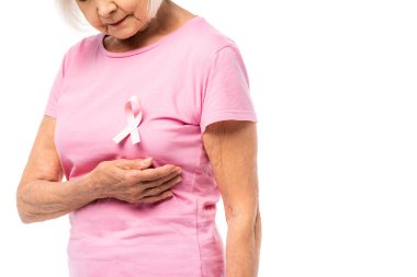 Cropped view of elderly woman in pink t-shirt with ribbon of breast cancer awareness isolated on white clipart