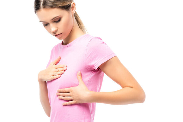 Young woman looking and touching breast isolated on white, concept of breast cancer