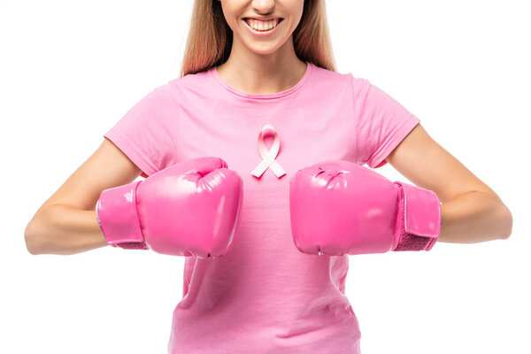 Cropped view of young woman with pink ribbon on t-shirt and boxing gloves isolated on white