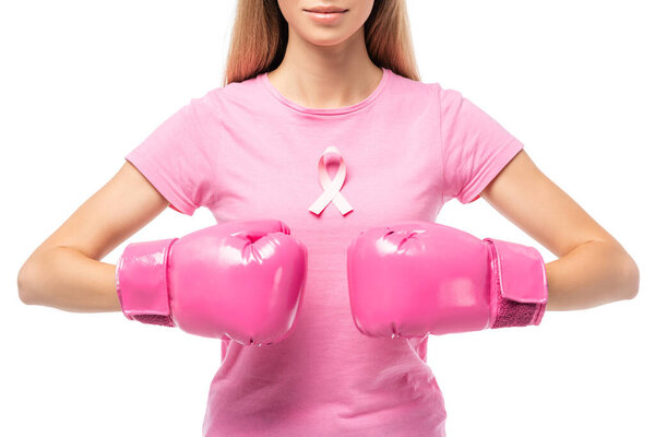 Cropped view of woman in pink boxing gloves and ribbon of breast cancer awareness isolated on white