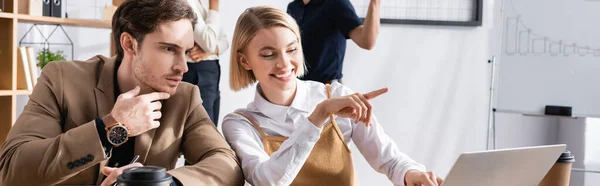 Focused Man Looking Laptop While Sitting Happy Woman Pointing Finger — Stock Photo, Image