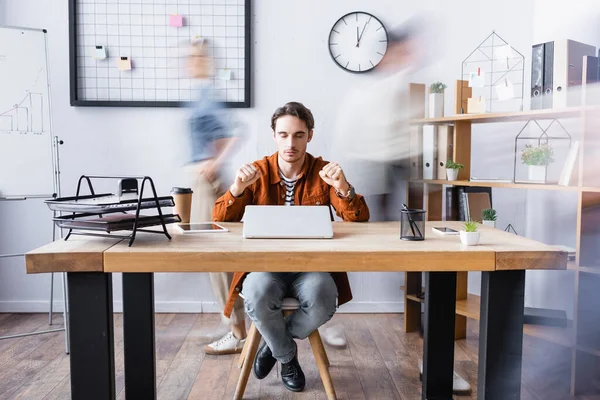 Young Manager Sitting Closed Eyes Clenched Fists Desk Open Space — Stock Photo, Image