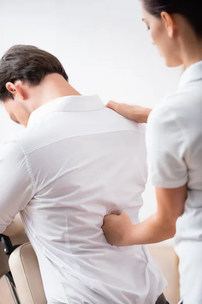 Masseuse Massaging Back Businessman Sitting Massage Chair Blurred Background — Stock Photo, Image