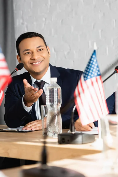 Smiling Indian Politician Pointing Hand While Looking Away Sitting Colleague — Stock Photo, Image