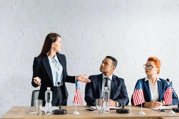 Female Politician Open Arms Looking Interracial Colleagues Sitting Boardroom — Stock Photo, Image