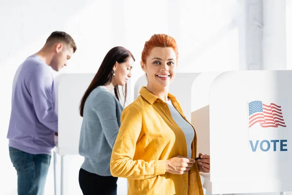 Woman Smiling Camera Polling Booth American Flag Vote Lettering Electors — Stock Photo, Image