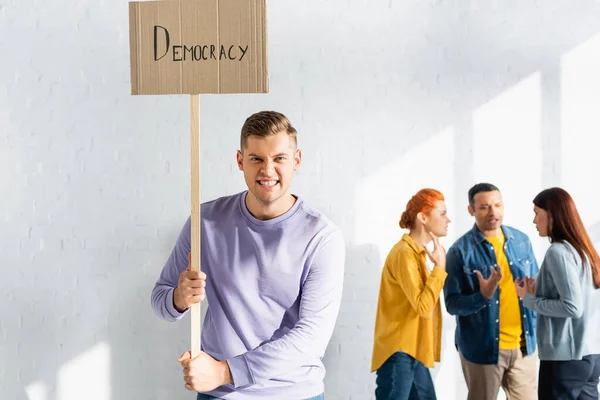 Angry Man Grimacing While Holding Placard Democracy Lettering Multicultural People — Stock Photo, Image