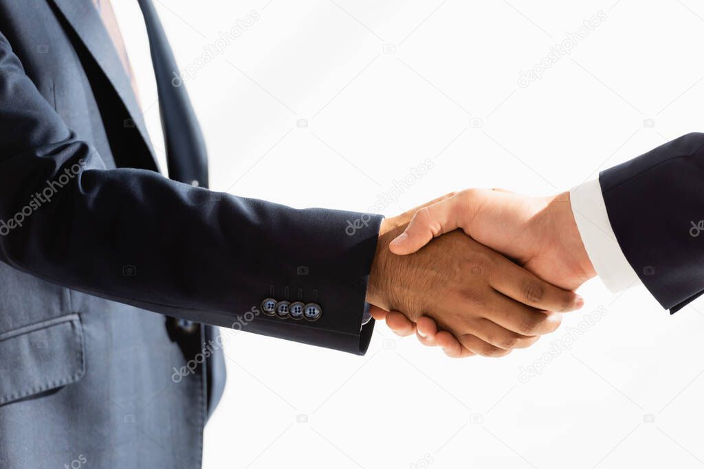 partial view of politicians shaking hands on white