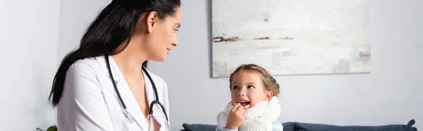 Pediatrician Doctor Looking Ill Girl Taking Pill Banner — Stock Photo, Image