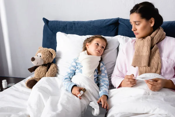 Madre Hija Enfermas Mirándose Mientras Sostienen Aerosol Nasal Termómetro — Foto de Stock