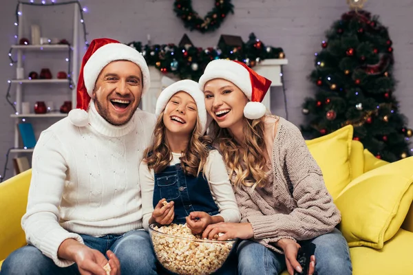 Happy Family Santa Hats Laughing Looking Camera Bowl Popcorn — Stock Photo, Image