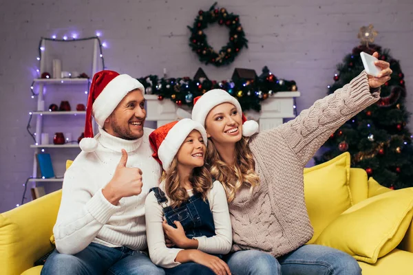 Joyful Family Santa Hats Taking Selfie Man Showing Thumb Decorated — Stock Photo, Image