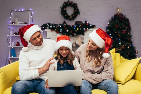 Joyful Kid Santa Hat Using Laptop Parents Decorated Living Room — Stock Photo, Image