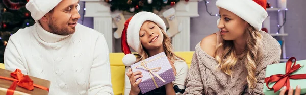 Joyful Family Santa Hats Holding Presents Decorated Living Room Christmas — Stock Photo, Image