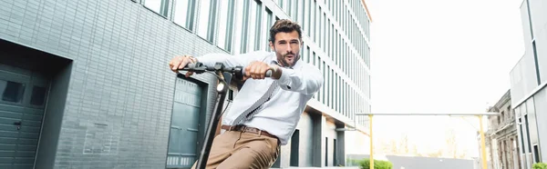 Surprised Businessman Formal Wear Riding Electric Scooter Building Banner — Stock Photo, Image