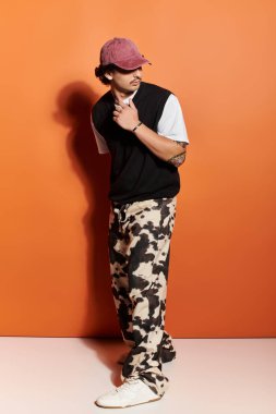 Yakışıklı, kendine güveni tam, modaya uygun giyinmiş, neşeli ama şık bir havası olan bir adam..