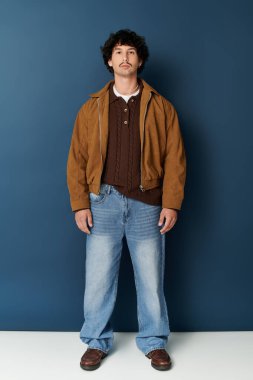 Kıvırcık saçlı yakışıklı genç adam rahat giyinmiş, havalı titreşimler yayıyor..