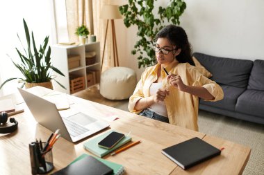 Güzel bir Afrikalı Amerikalı kadın şık ev ofisinde serbest çalışıyor..