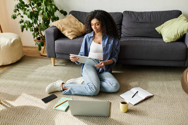 A young Black woman enjoys working from home in her chic apartment's ambiance.