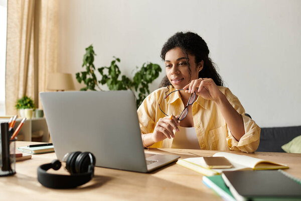 In a modern apartment, a young woman focuses on her work while enjoying remote flexibility.