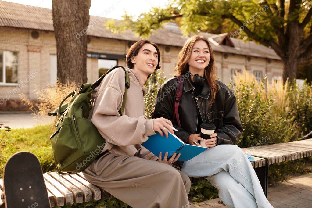 A loving couple sits side by side on a bench, sharing smiles and drinks in the sun.