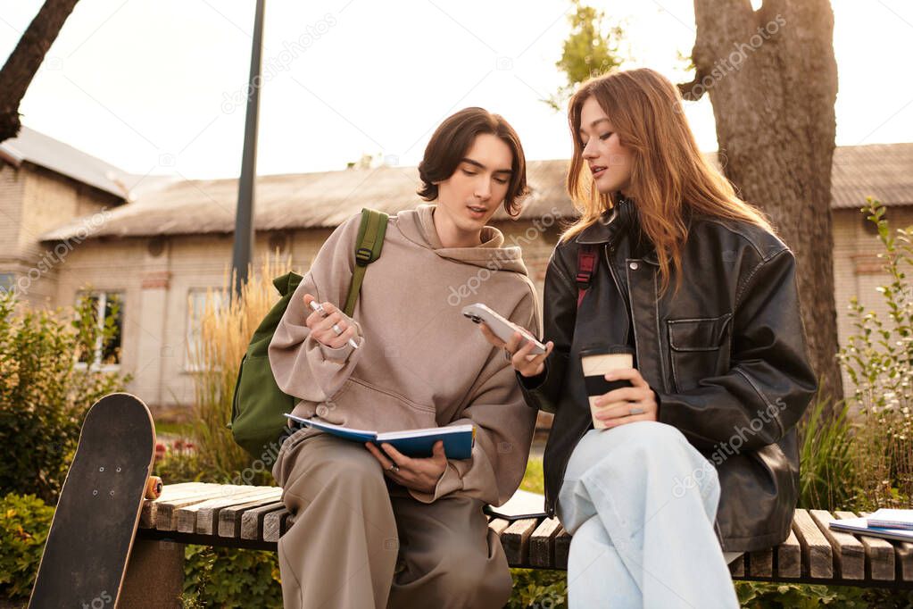 Loving couple sits on a bench, sharing smiles and conversation in a sunny outdoor park.