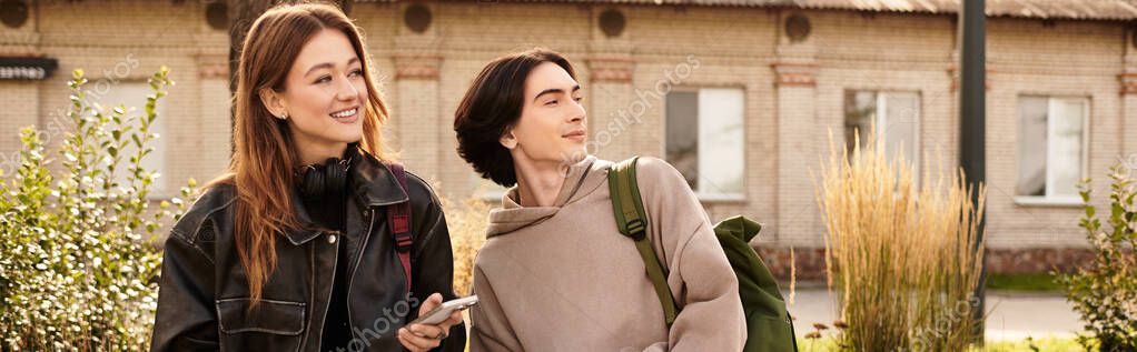 Sweet couple enjoys each others company while exploring a vibrant outdoor location.