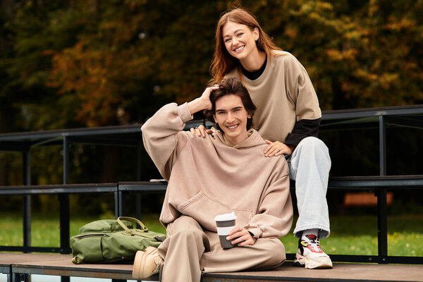 Couple sits together on a bench smiling, enjoying each others company in a lush setting