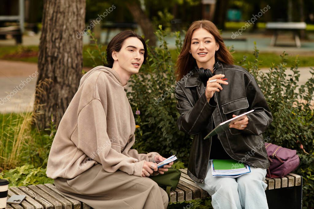 A young couple sits together on a bench, enjoying each others company in a vibrant park.