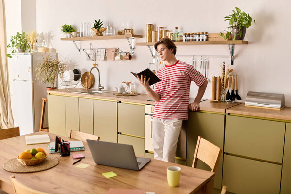 Молодой человек сосредоточился на обучении, изучении материалов на своем стильном домашнем столе.