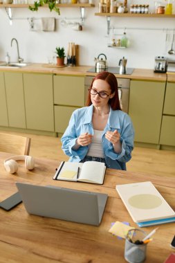 A passionate language teacher with red hair teaches online from her home, connecting with students.
