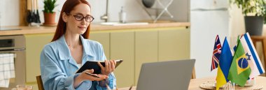 Woman with red hair teaches language classes online from her stylish home workspace, using a laptop, banner
