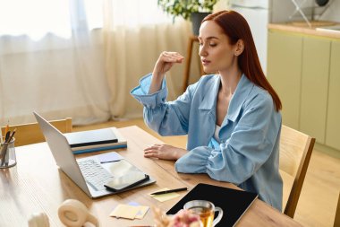 Red-haired woman teaches languages online, offering an interactive home learning experience.