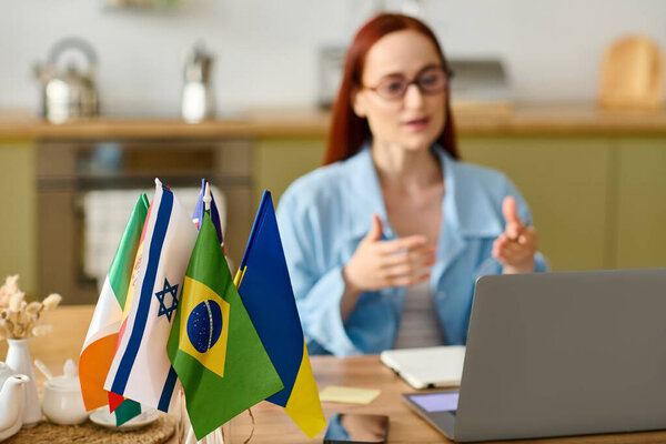 A woman with red hair teaches languages remotely, engaging students through her laptop.