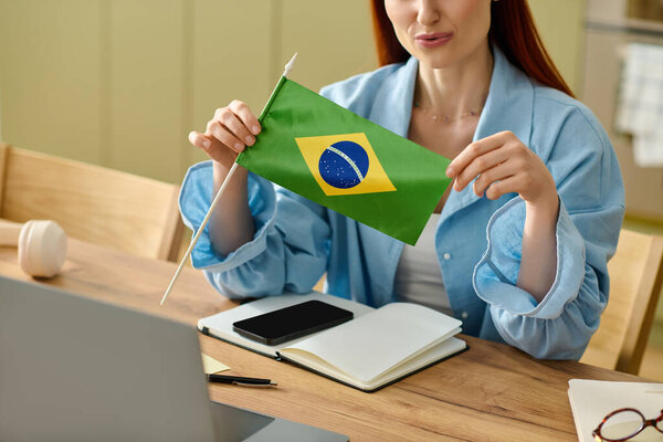 Red-haired teacher conducts an online lesson about Brazilian language and culture at home.