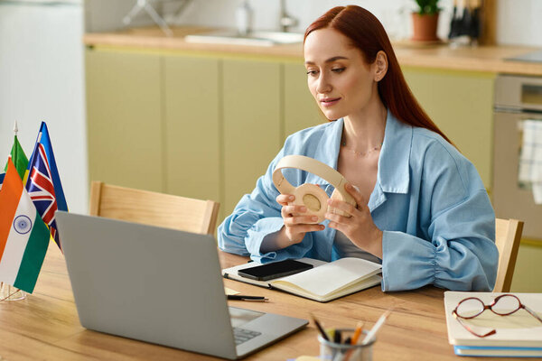 A woman with red hair teaches languages online from her cozy home workspace using a laptop.