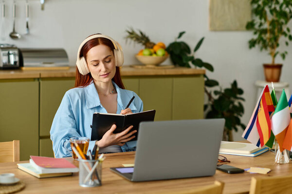 Language teacher with red hair focuses on lesson planning while sitting at her home workspace.