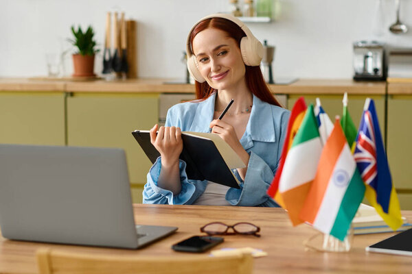 A language teacher with red hair teaches online while sitting at a cozy kitchen table.
