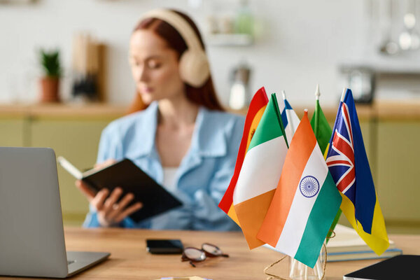 A woman with red hair teaches languages online from her home, engaged and focused on her laptop.