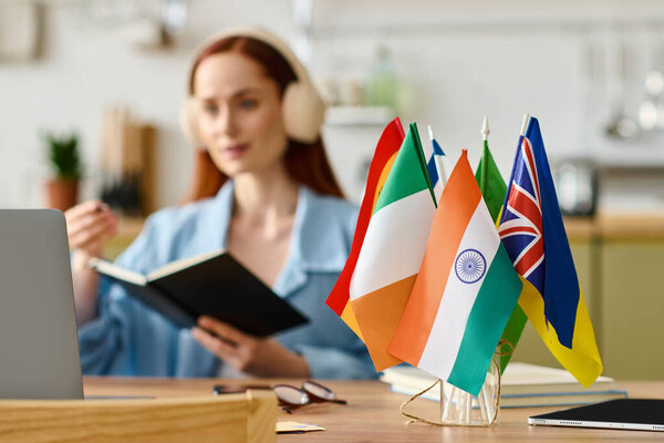 Woman with red hair teaches languages online, using a laptop in her comfortable home workspace.