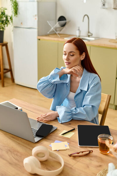A red-haired teacher conducts an online language class from her cozy home office.